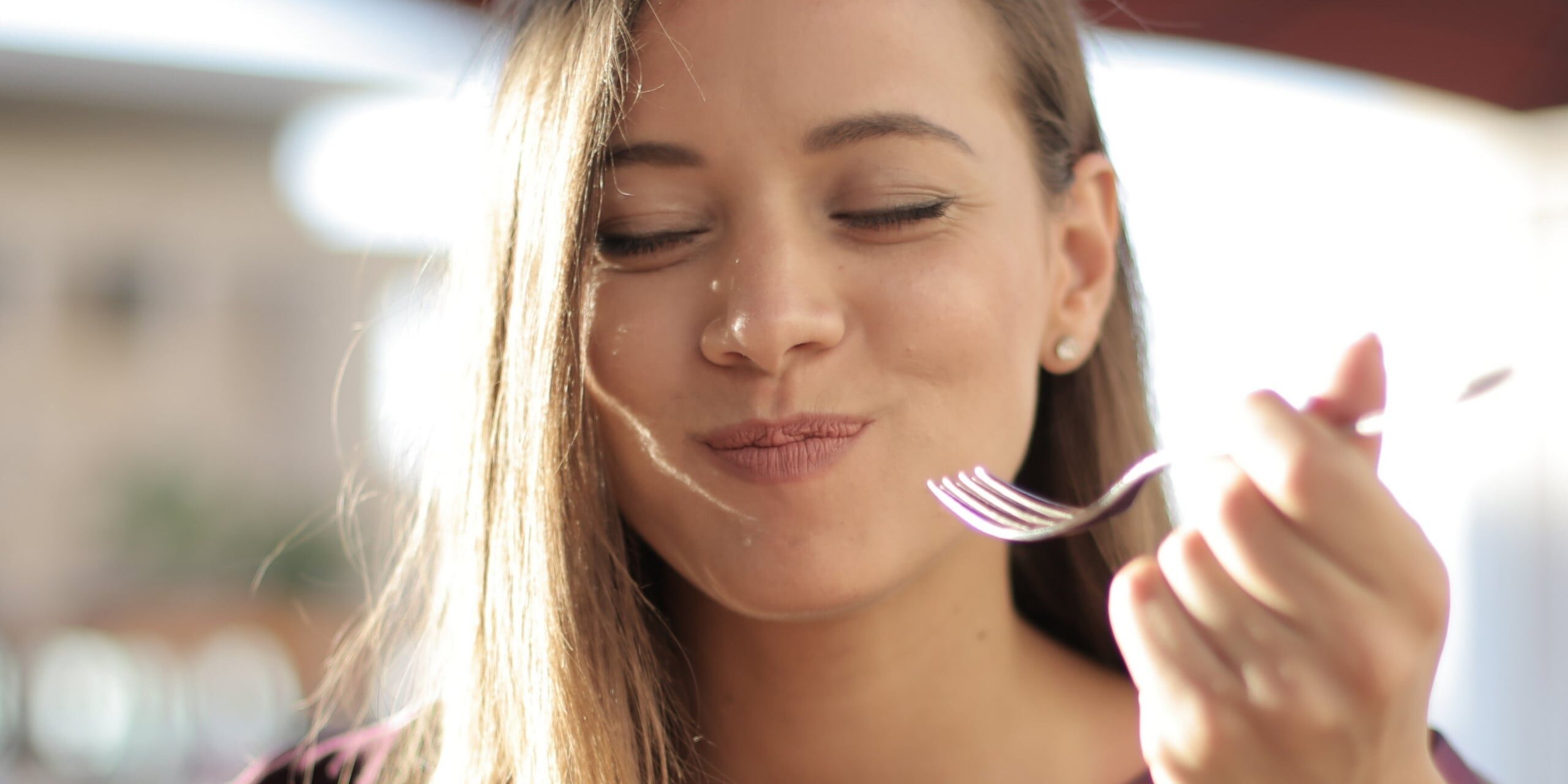 Woman_Eating_With_Fork_Contemplating_With_Eyes_Closed