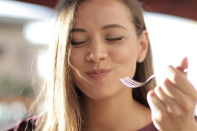 Woman_Eating_With_Fork_Contemplating_With_Eyes_Closed